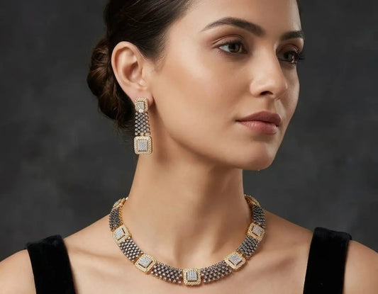Woman wearing a necklace and earrings against a dark background