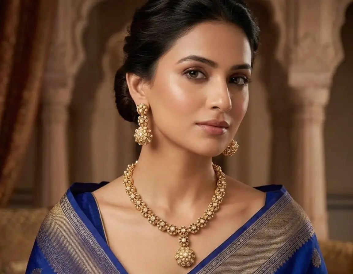 Woman wearing gold jewelry with a blue and gold traditional outfit.